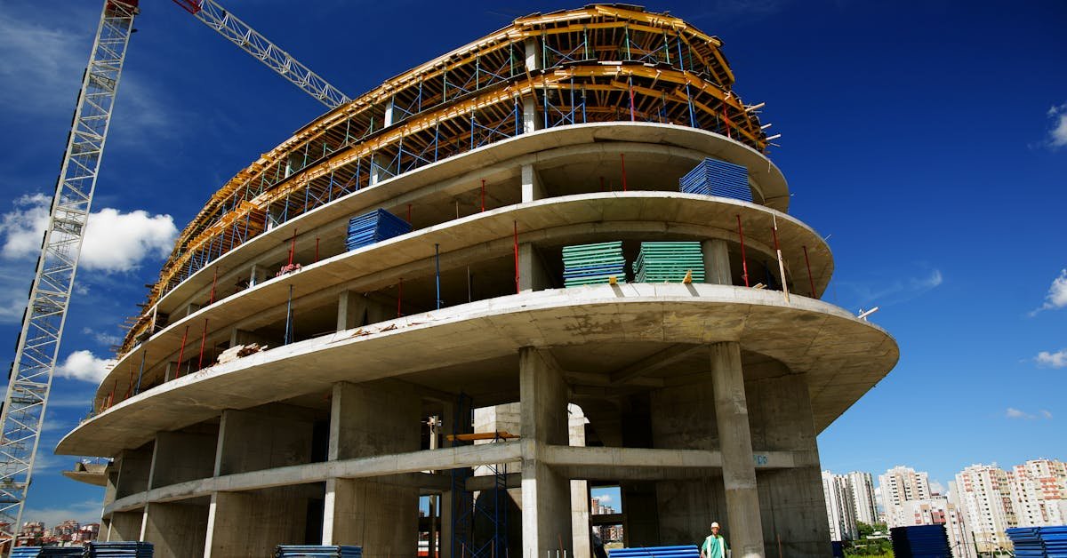 Multi-storey commercial building under construction with exposed structural elements, illustrating common survey defects