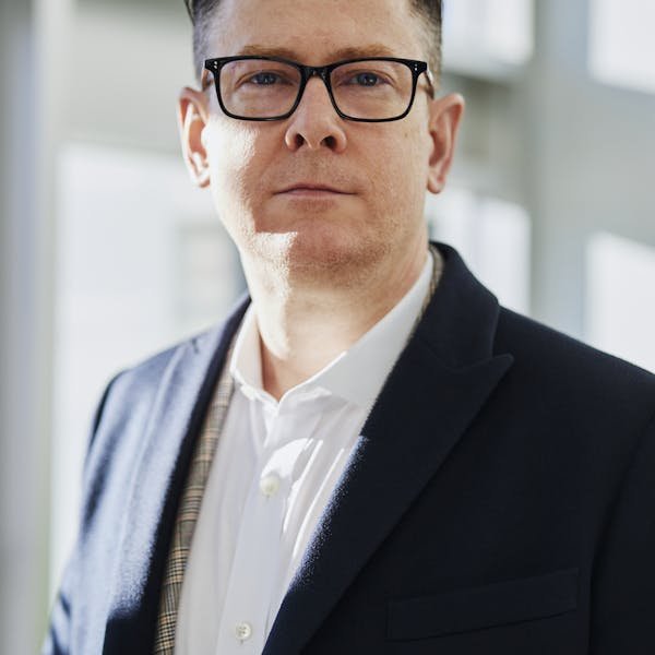 Jonathan Hargreaves, Founder and Lead Commercial Building Surveyor, standing confidently in a modern UK commercial building reception